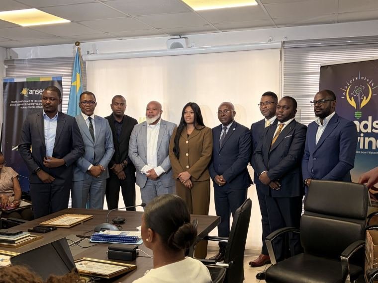Photo de groupe des participants et des intervenants, les certificats posés sur la table.